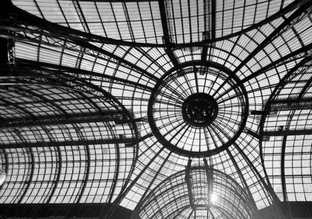 The Grand Palais glass dome from directly below, the steel radiating out with the sun burst through it.