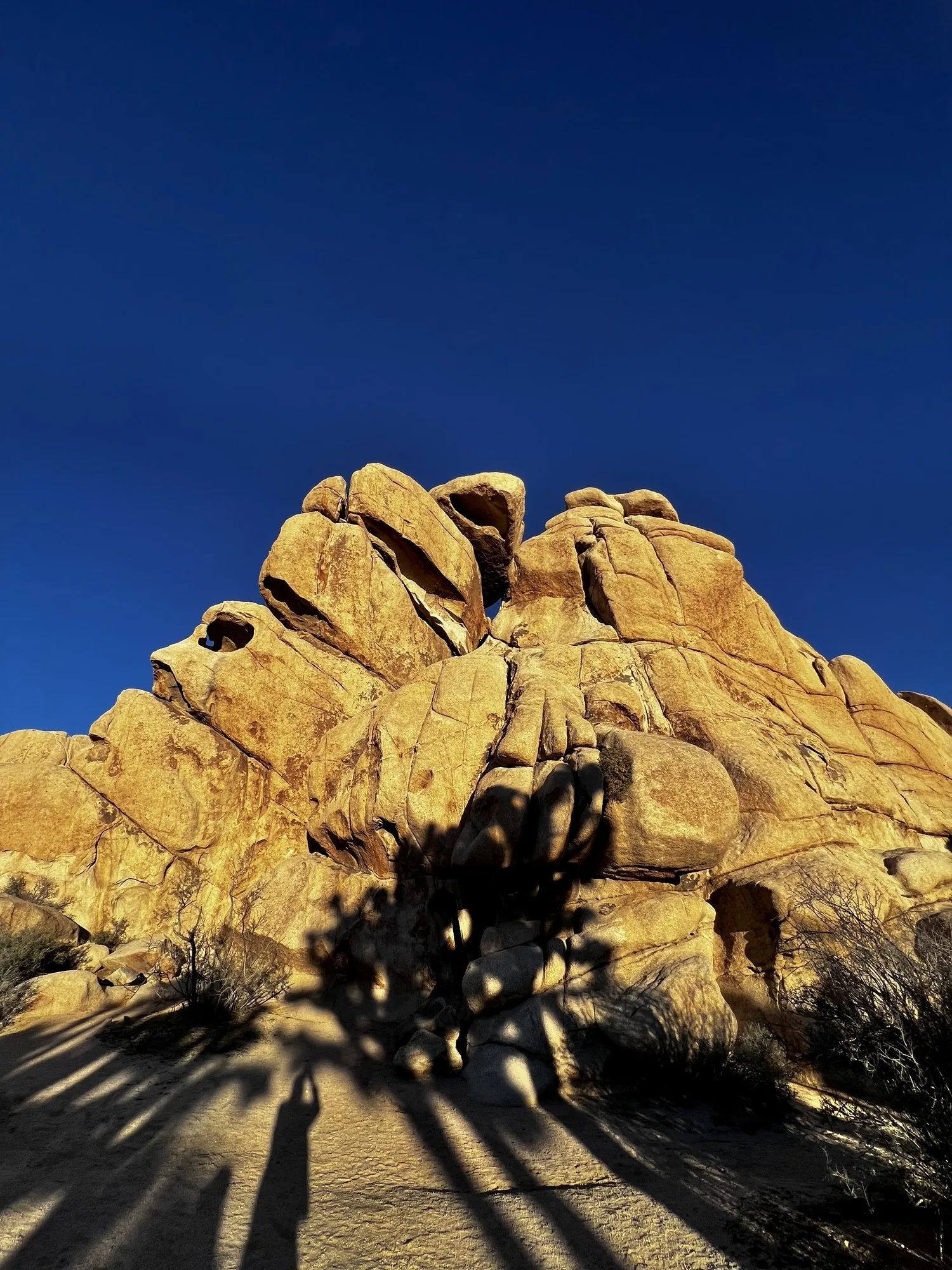 Rock with long shadows radiating off it.