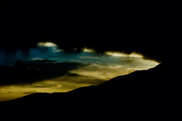 A black ridge with one slash of gold cloud.