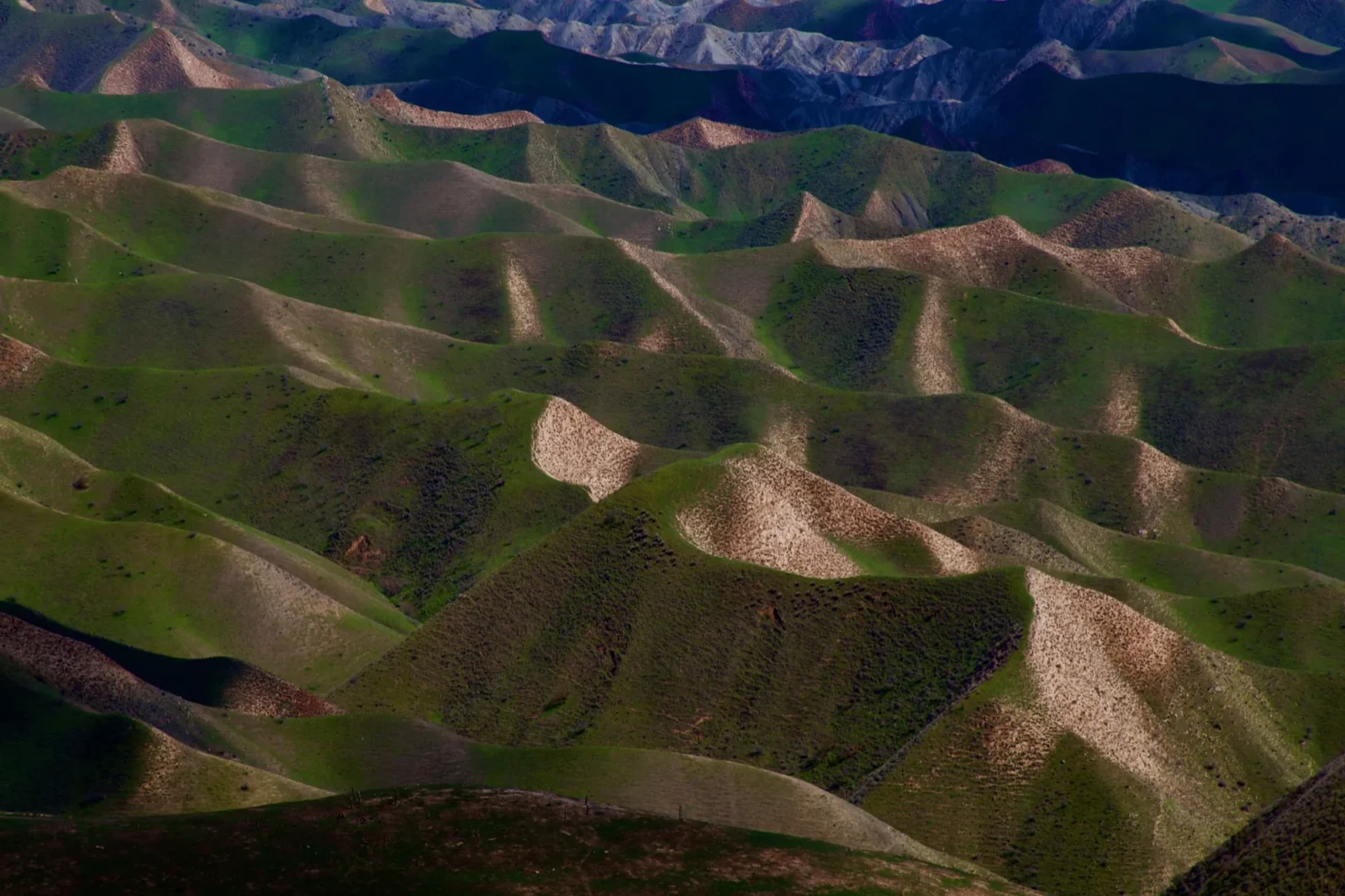 Layered ridges, green into pink.