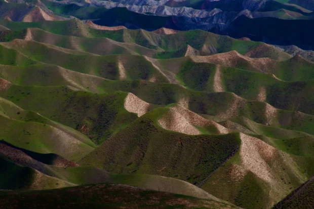 Layered ridges, green into pink.