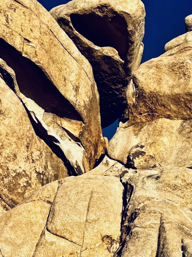 Gold rock slabs against deep blue, read as planes rather than as a place.