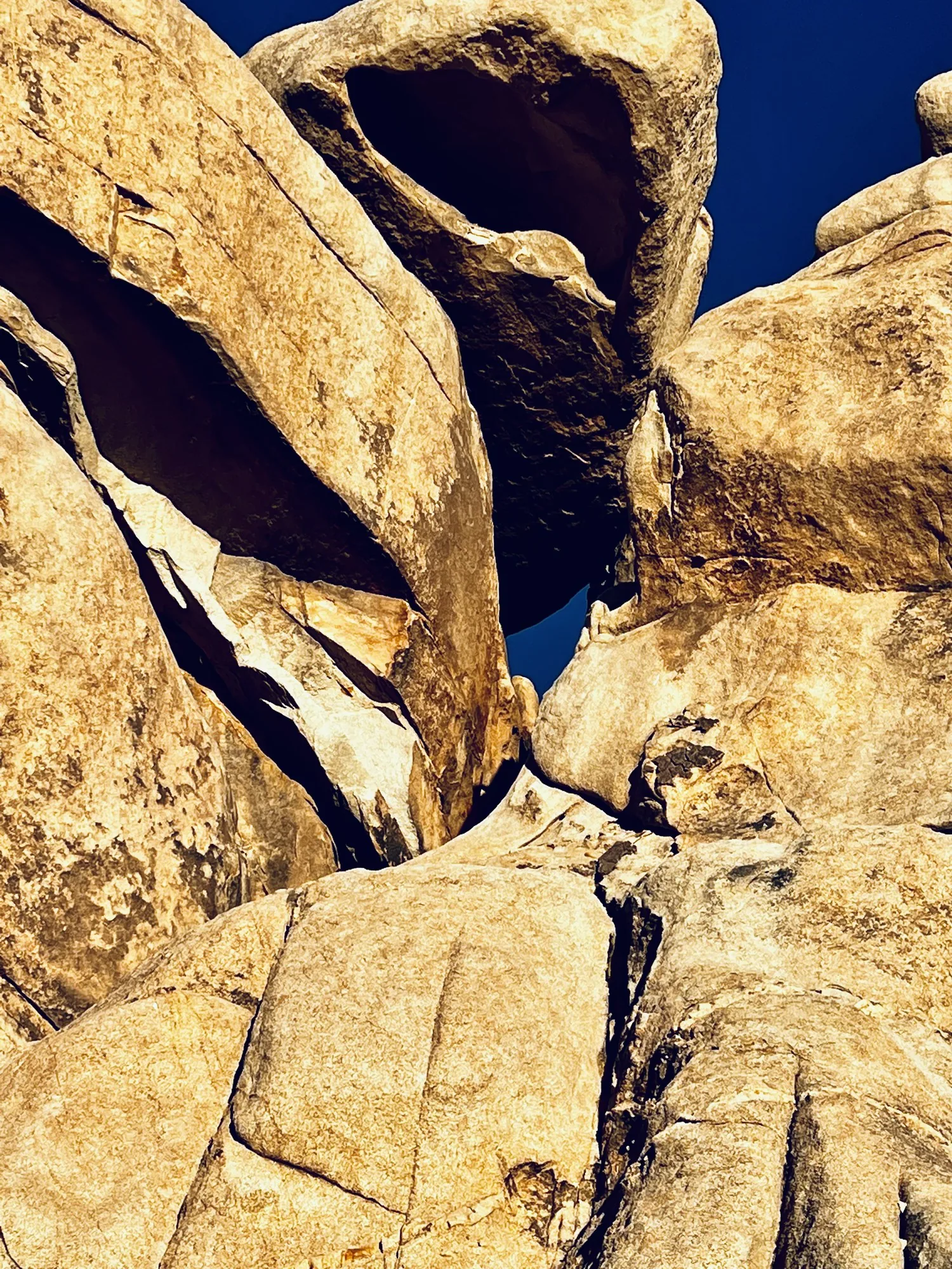 Gold rock slabs against deep blue, read as planes rather than as a place.