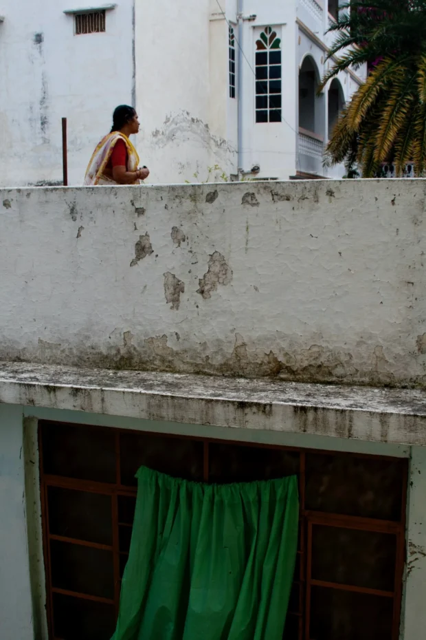 A figure on a white rooftop.