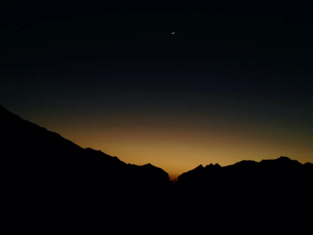 A mountain edge with the last light behind it.