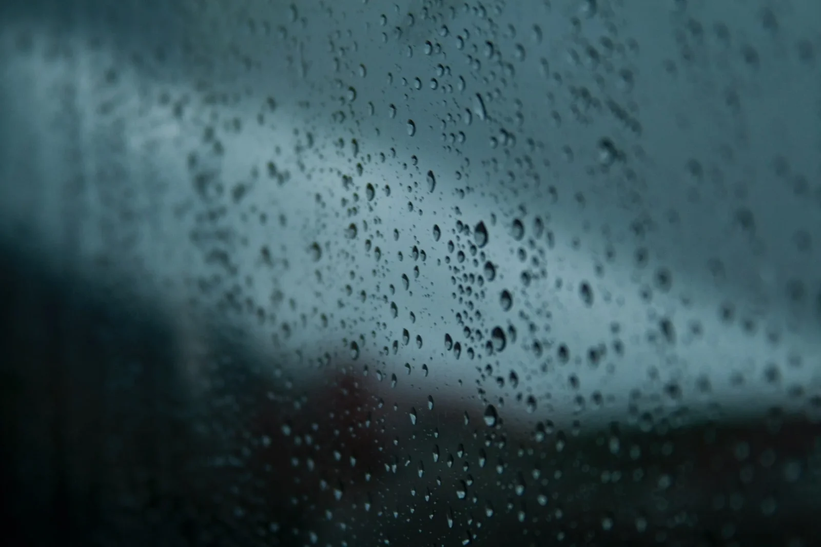 Rain on glass with the world going soft behind it.